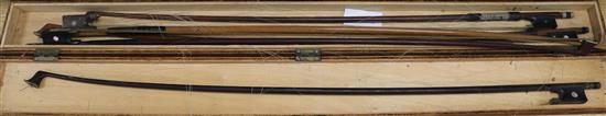 A group of assorted violin bows
